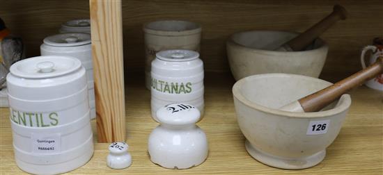 A collection of white glazed terracotta storage jars, two marble pestles and mortars, etc.